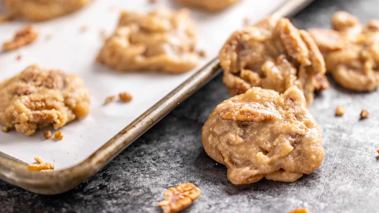 Pecan pralines on a cookie sheet.