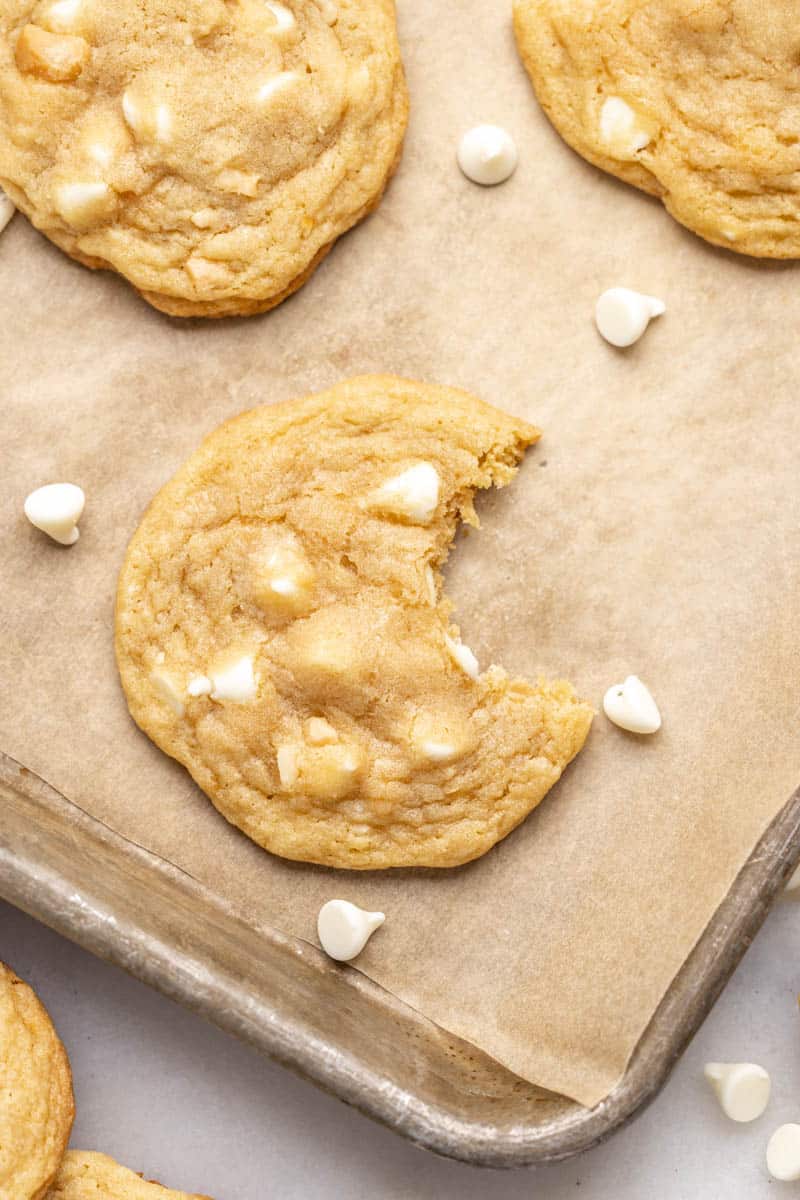 Baking sheet filled with white chocolate macadamia nut cookies.