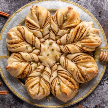 Overhead view of a loaf of Baklava star bread on a silver platter.