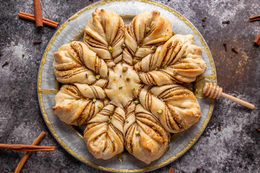 Overhead view of a loaf of Baklava star bread on a silver platter.
