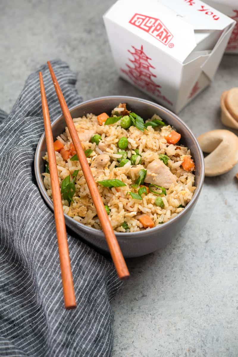 Chicken fried rice with chopsticks on top.