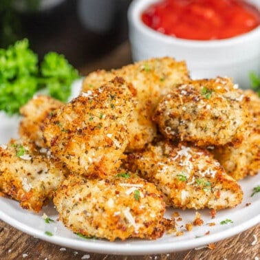 Air fryer chicken nuggets on a dinner plate.