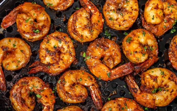 Overhead view of shrimp in an air fryer.
