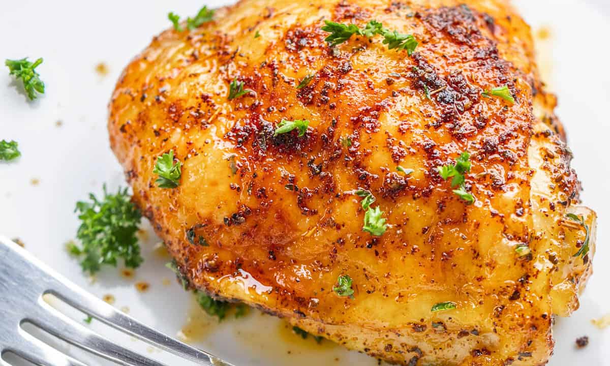 Close up view of a chicken thigh cooked in an air fryer.