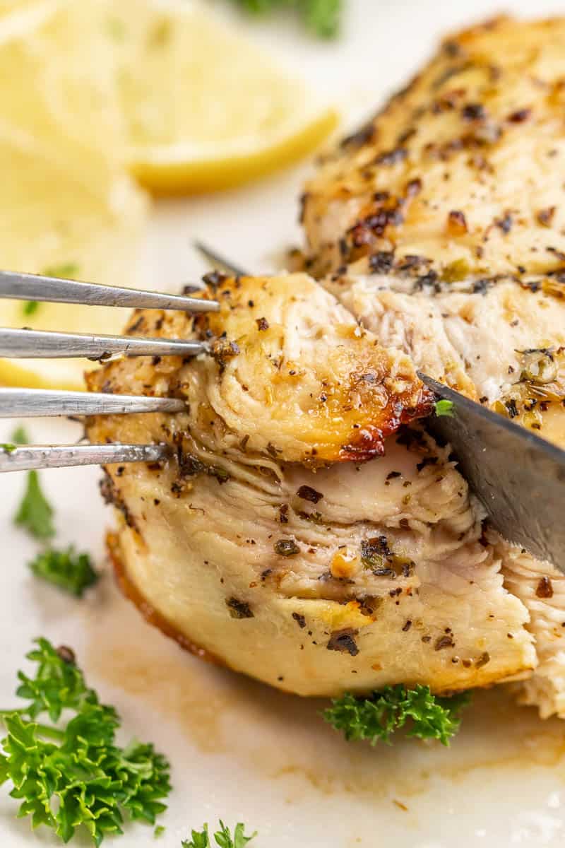 Close up view of cutting into a chicken breast.