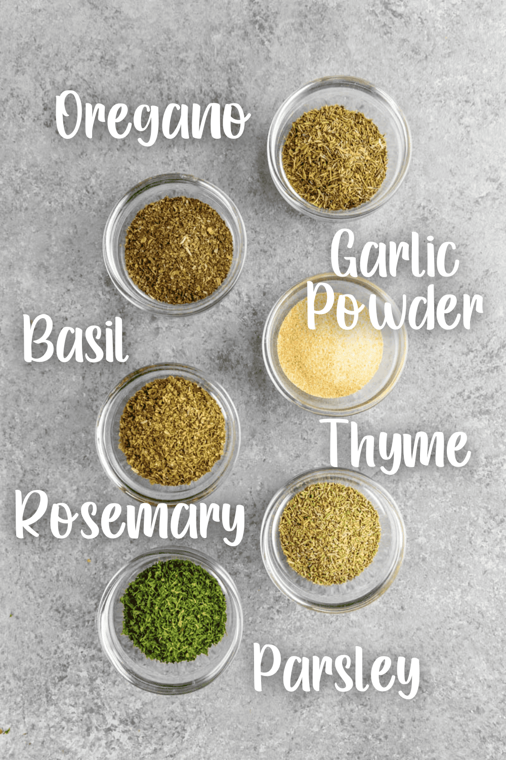 Individual seasonings to make Italian seasoning in small glass bowls.