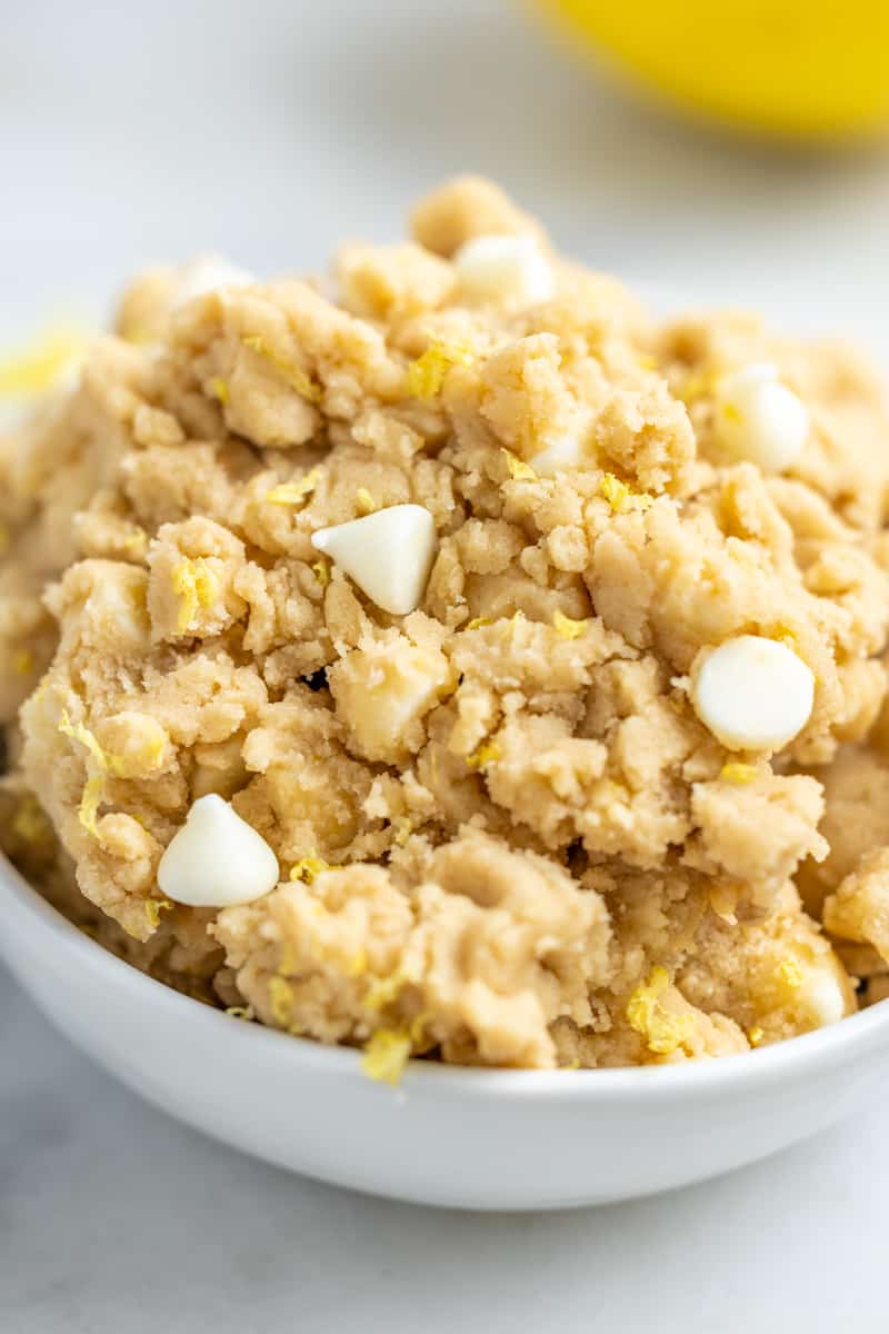 Close up view of a bowl filled with lemon cookie dough.