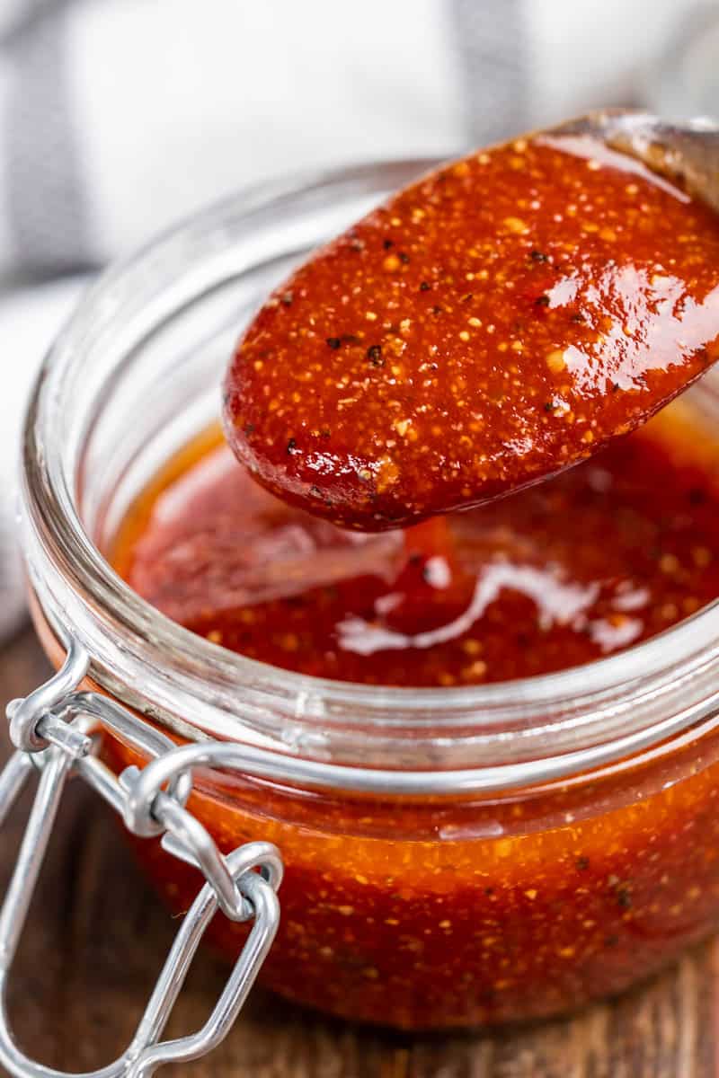 Close up of a spoonful of barbecue sauce.