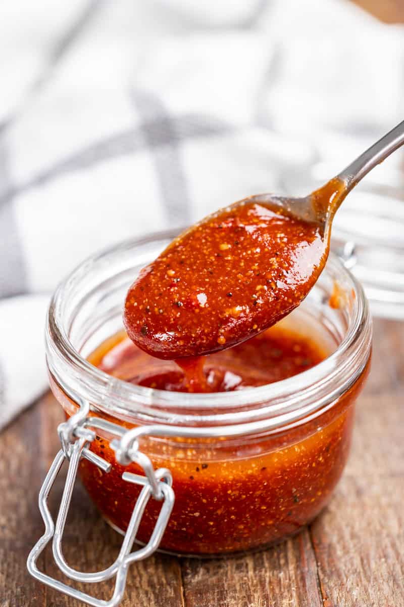 Homemade barbecue sauce in a glass canister.