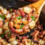 A wooden spoon with corned beef hash.