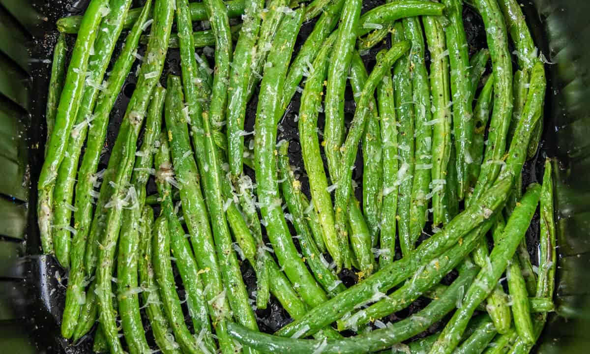Overhead view of green beans looking into an air fryer basket.
