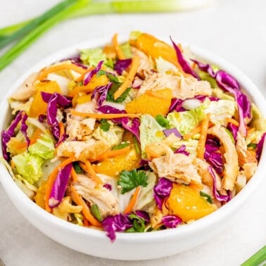Chinese chicken salad in a white serving bowl.