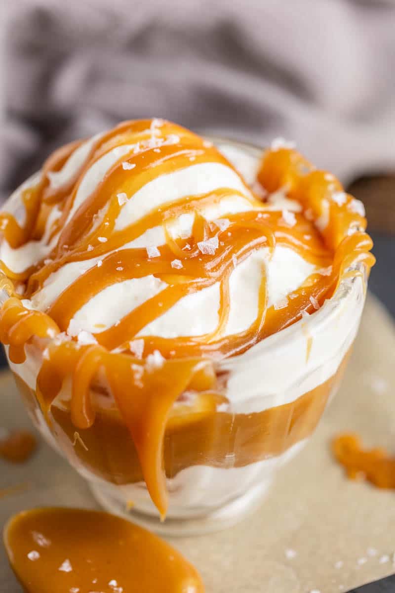 Close view of sea salt caramel sauce in glass bowl with ice cream.