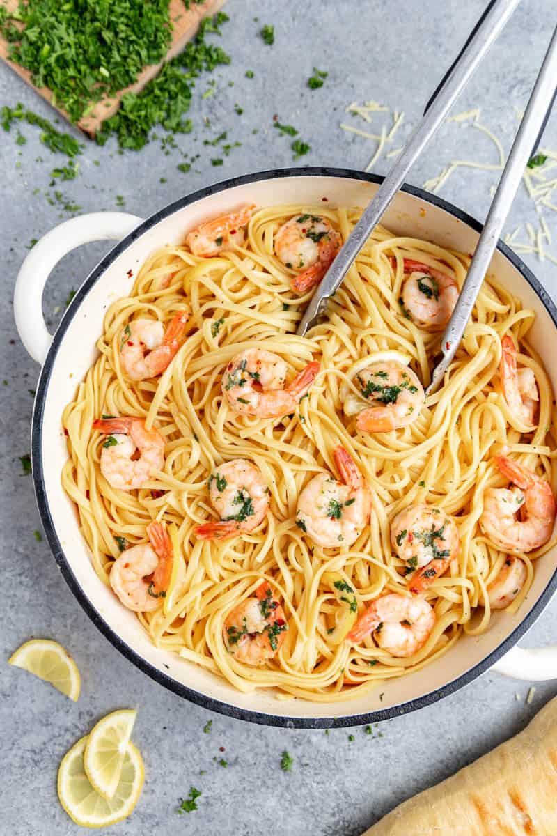 Peering into a large pot of shrimp linguine.