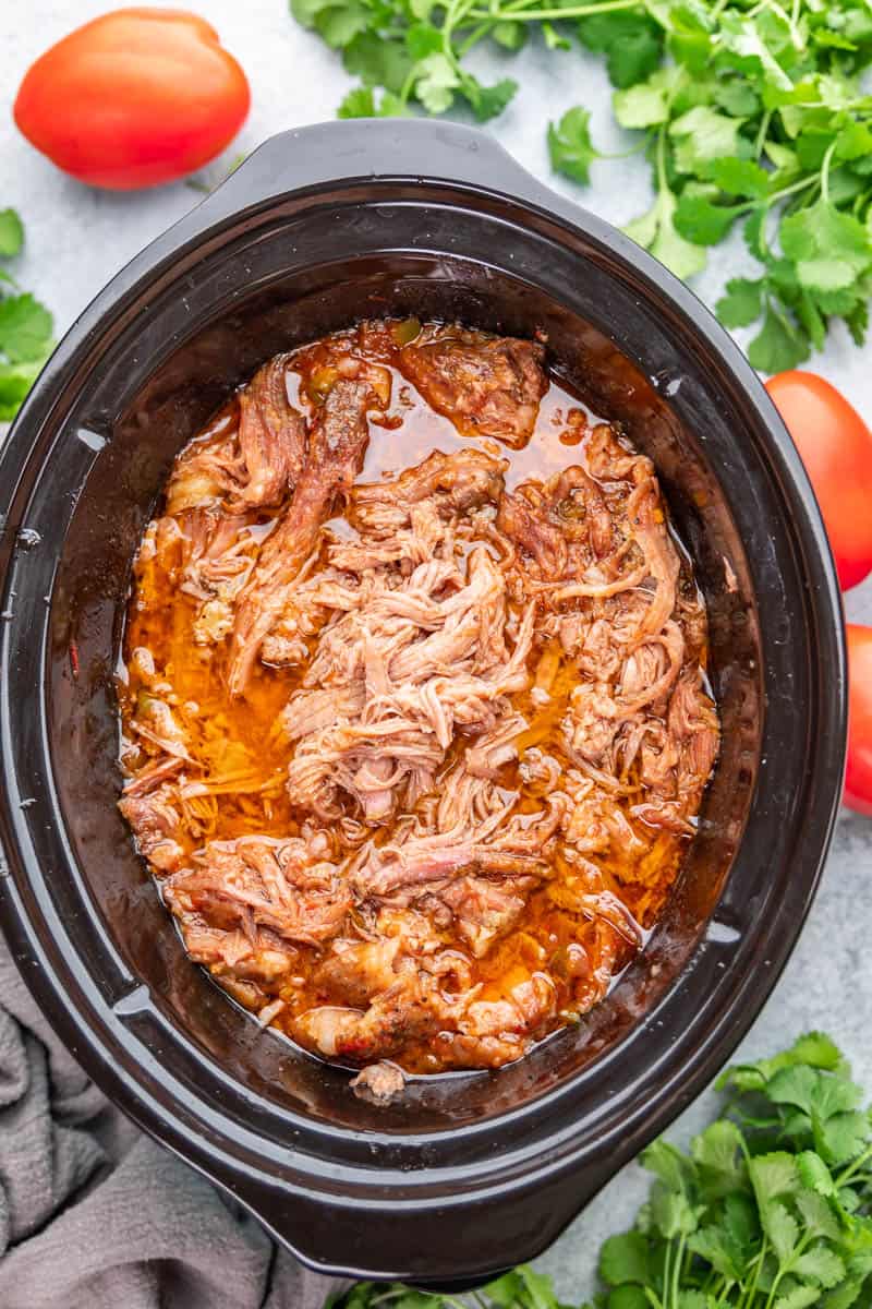 Overhead view looking into a slow cooker filled with sweet pork.
