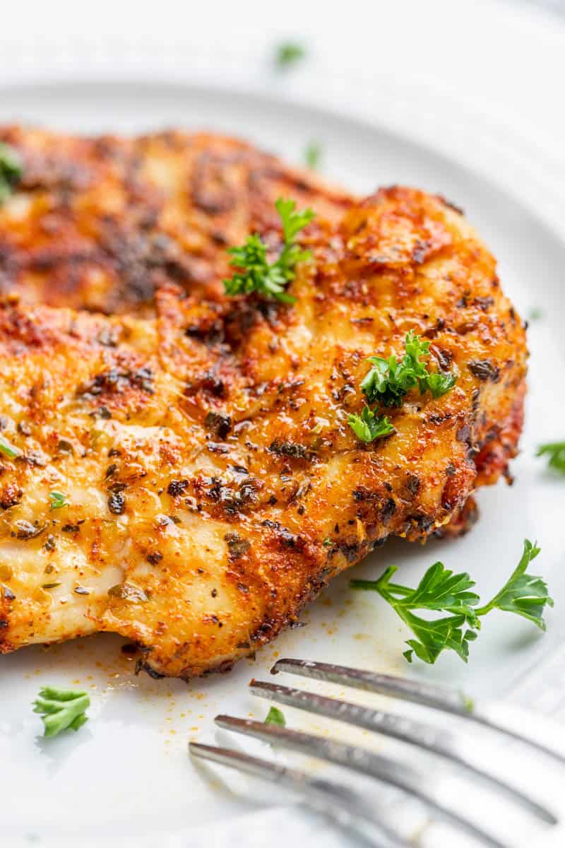 Naked chicken tenders garnished with parsley.