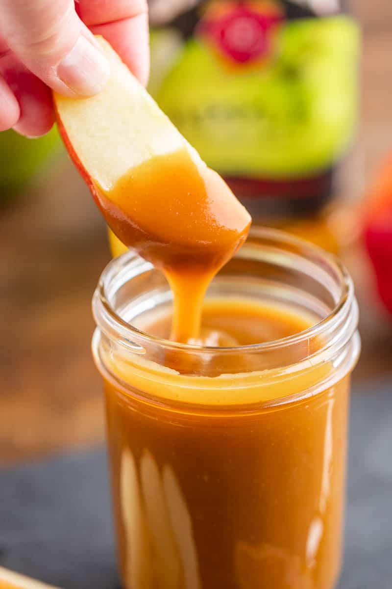 An apple dipped in apple bourbon caramel sauce.