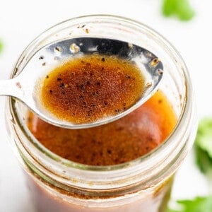 Close up overhead view of Asian dressing on a spoon.