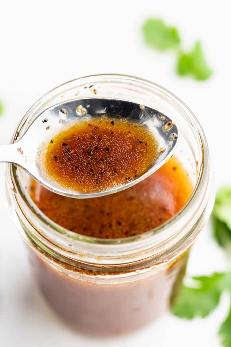 Close up overhead view of Asian dressing on a spoon.