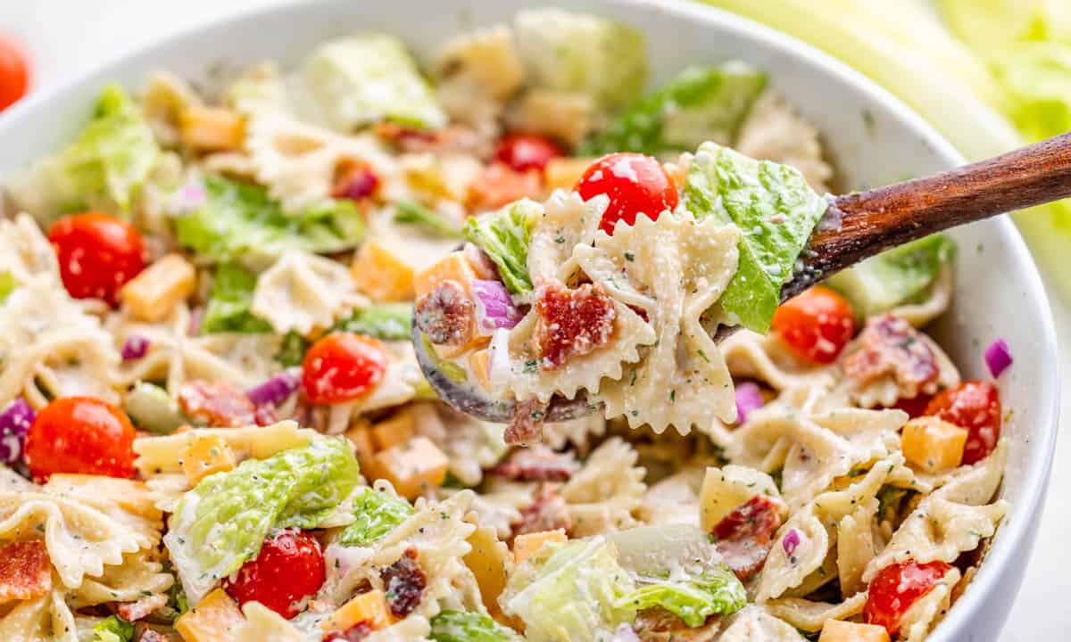Close up view of BLT pasta salad in a serving bowl.