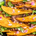 Close up view of birria tacos.