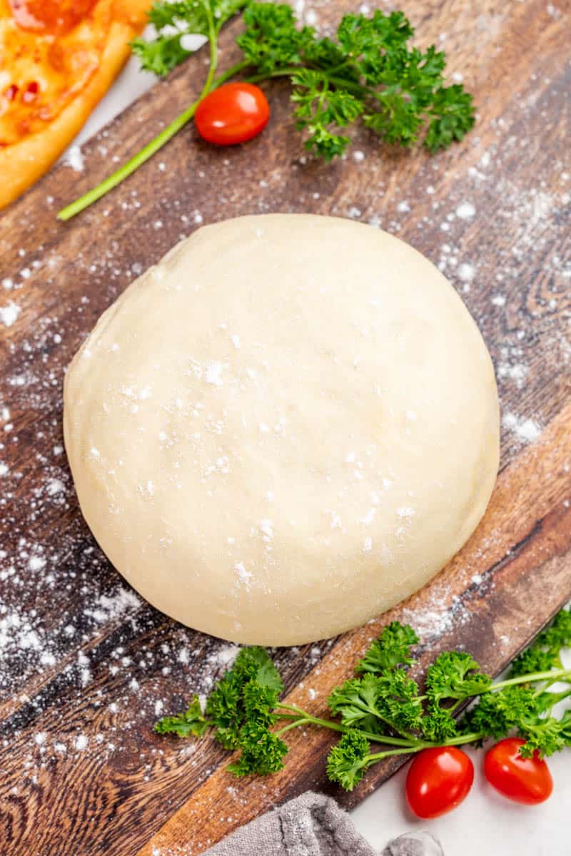 Overhead view of a ball of homemade pizza dough.