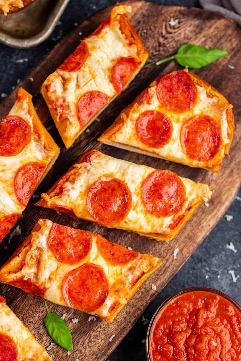 An overhead view of a French bread pizza cut into slices.