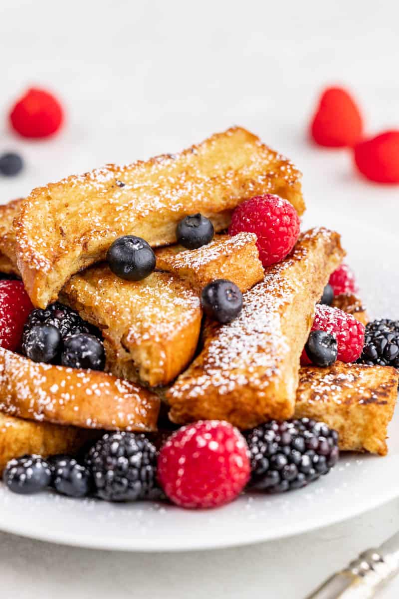 Close up view of French toast sticks on a plate.