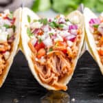 Close-up view of pulled pork tacos.