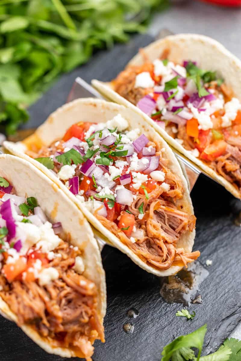 Pulled pork tacos on a taco stand.