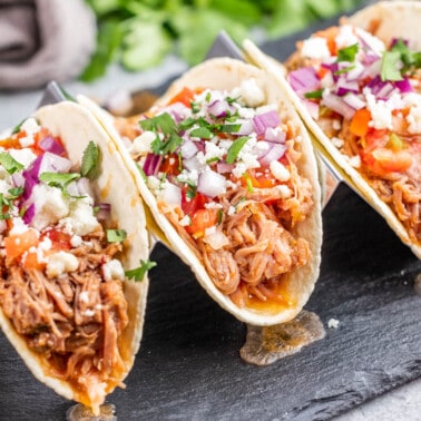 Pulled pork tacos in a taco stand.