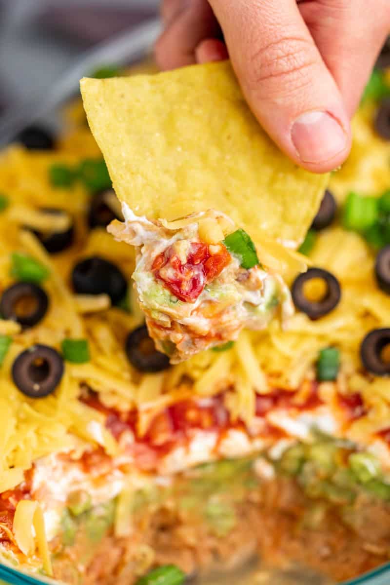 A chip dipped into 7 layer dip.