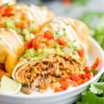 An air fried chimichanga on a white plate.