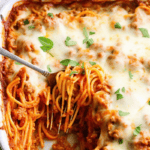 Baked Spaghetti in a casserole dish with a fork sticking in it.
