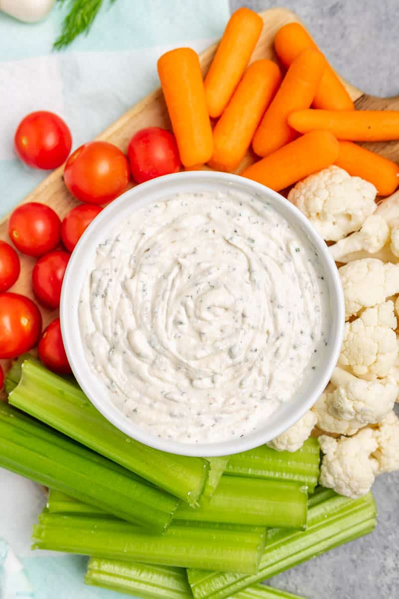 Top view of a white bowl with homemade ranch dip.