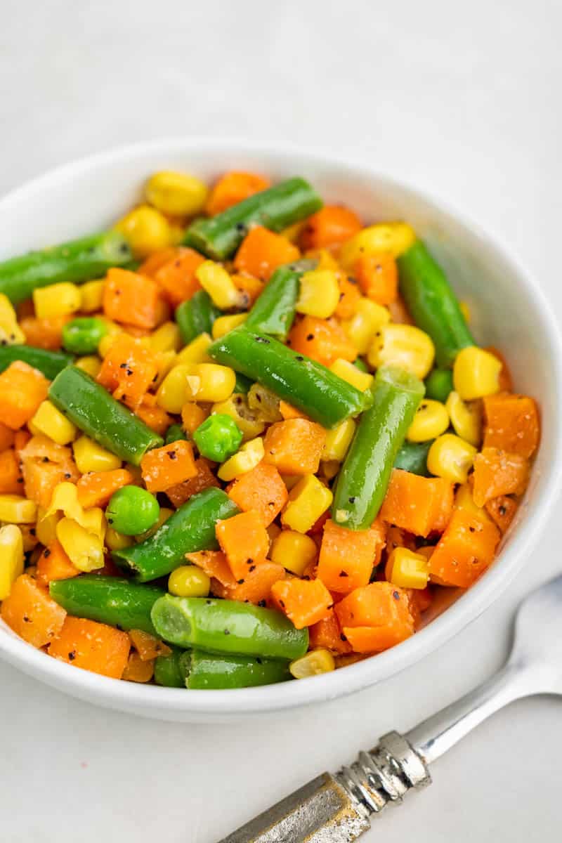 A white bowl filled with mixed vegetables.