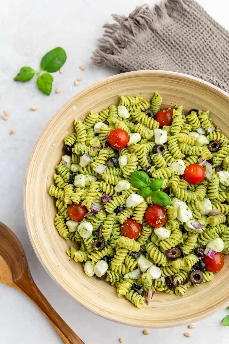 Overhead view of pesto pasta salad in a dinner bowl.