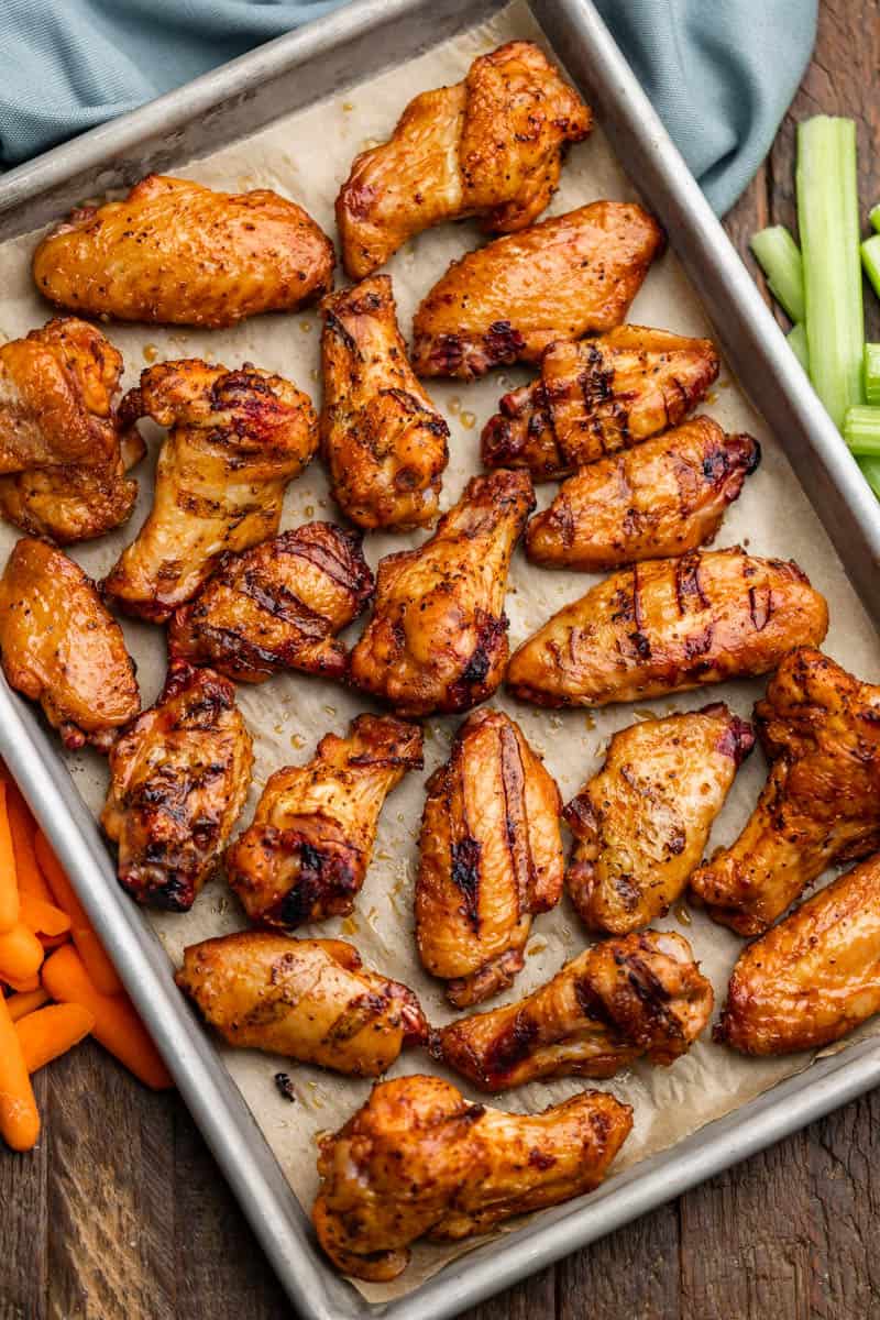 Overhead view of smoked. chicken wings on a baking sheet.