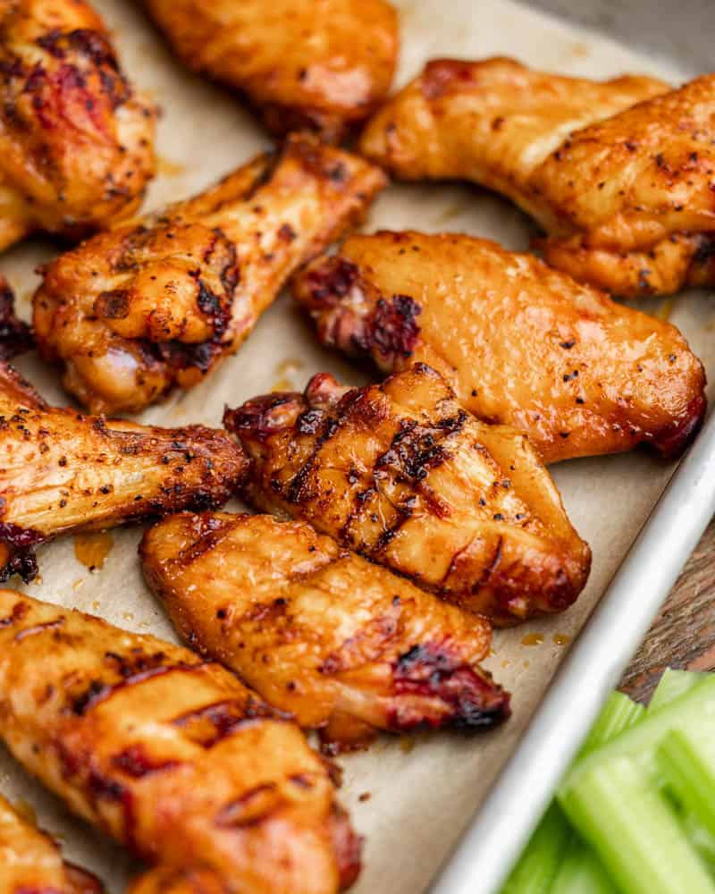 Overhead view of smoked chicken wings on a baking sheet.