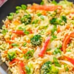 Close up view of vegetable fried rice in a wok.