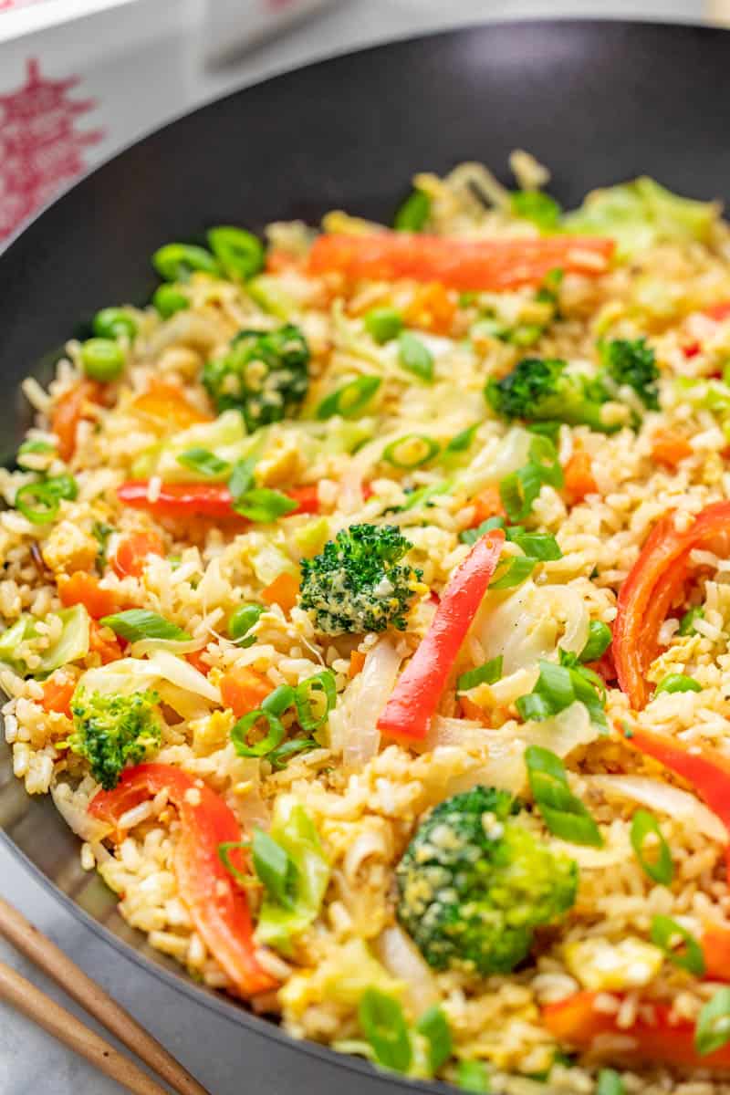 Close up view of vegetable fried rice in a wok.