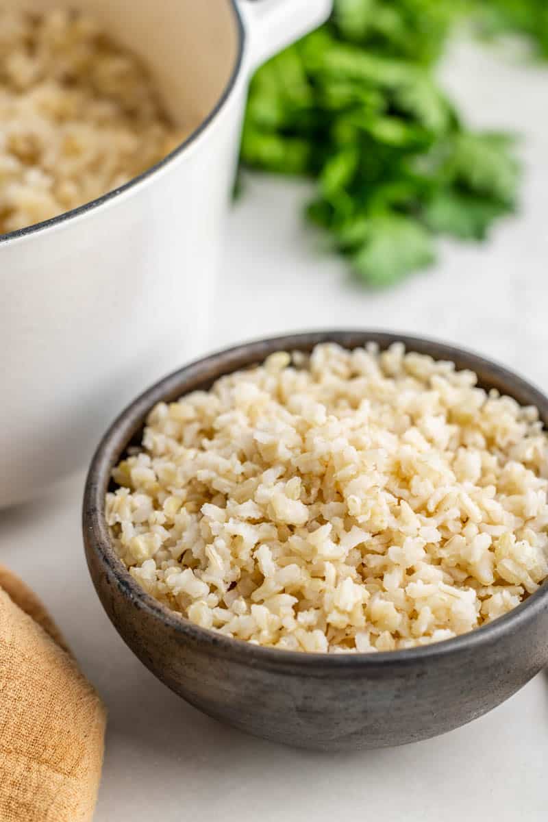 Brown rice in a black bowl.