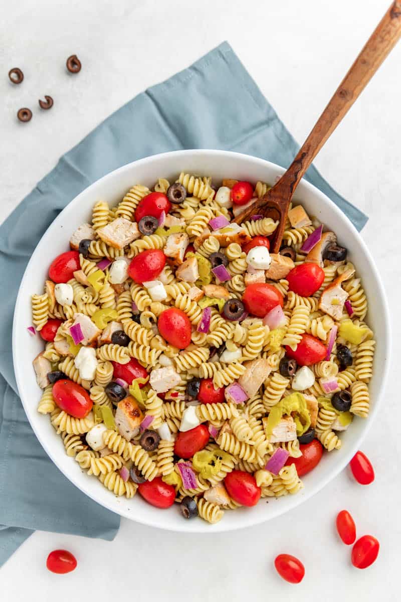 Overhead view looking into a bowl of chicken pasta salad.