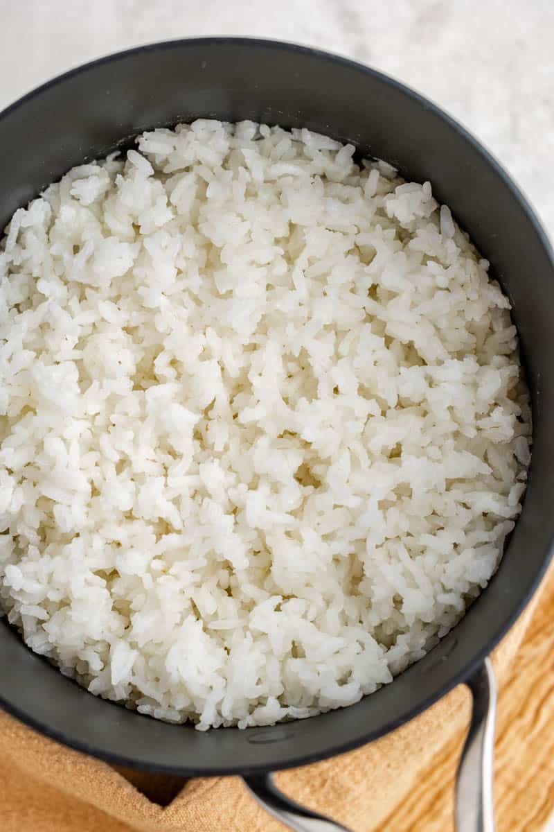 Overhead view looking into a pot filled with white rice.