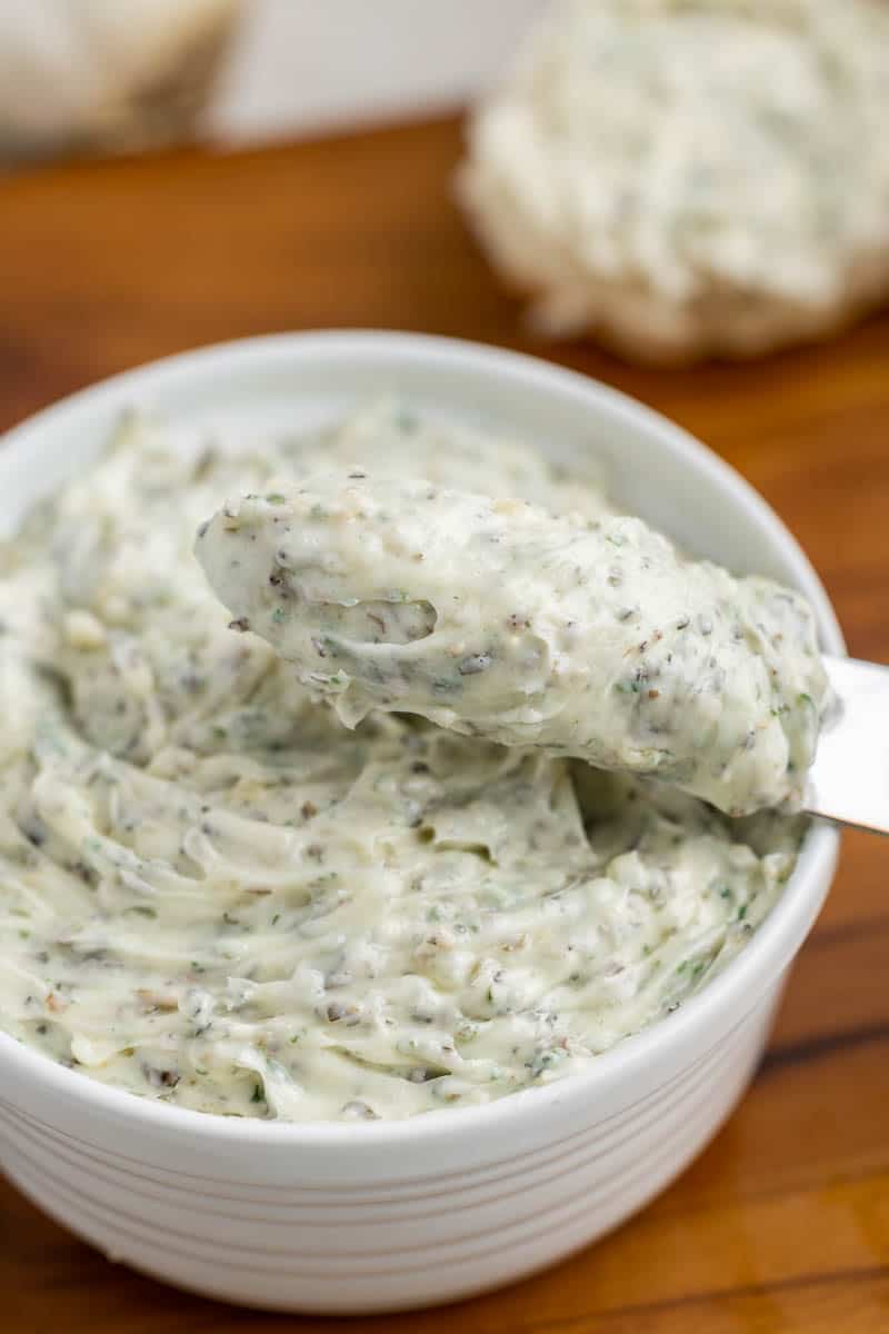 Overhead view of homemade garlic butter in a small white dish.