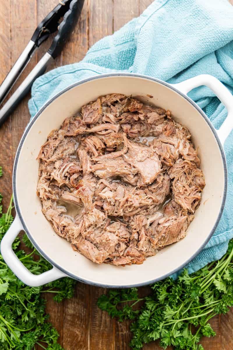 Top view of a Dutch oven with grilled pulled pork.