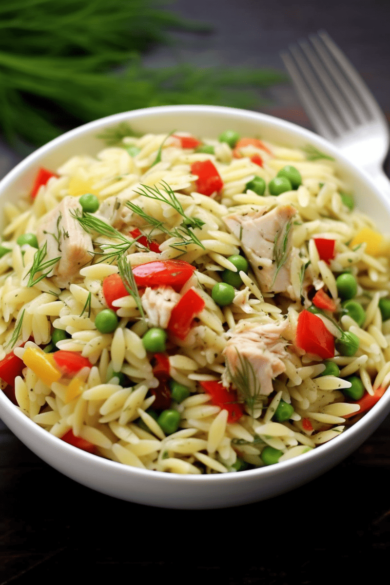Overhead view of Lemon-Dill Orzo Pasta Salad with Chicken in a white bowl.