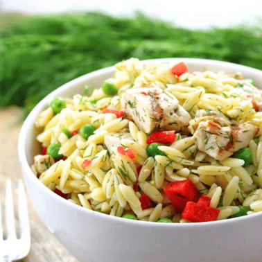 Lemon-Dill Orzo Pasta Salad with CHicken in a white bowl.