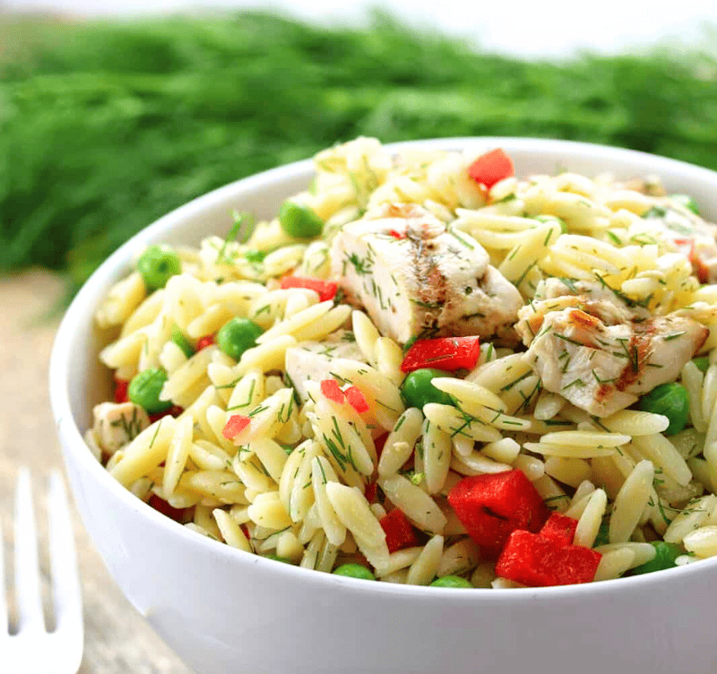 Lemon-Dill Orzo Pasta Salad with CHicken in a white bowl.