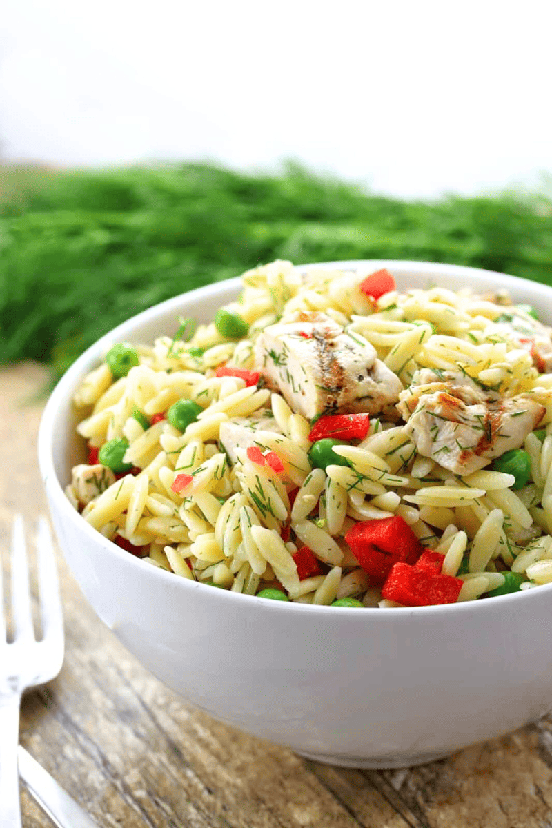 Lemon-Dill Orzo Pasta Salad with CHicken in a white bowl.